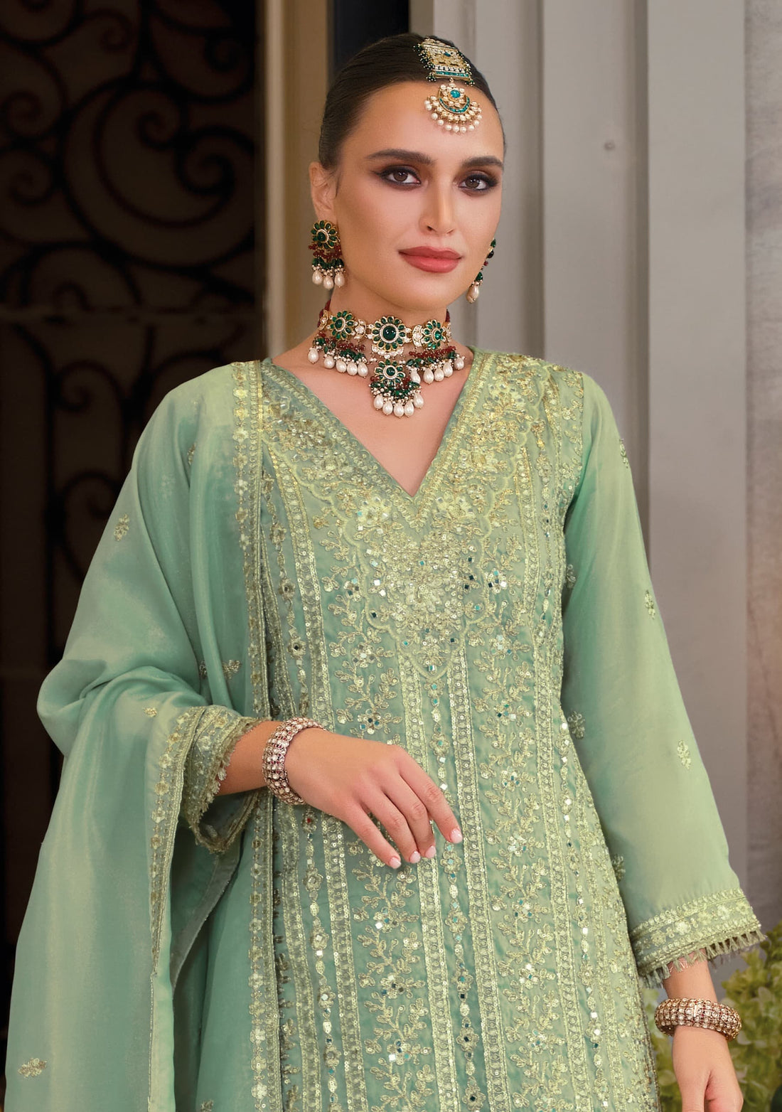 Front of a model stranding wearing a green sharara