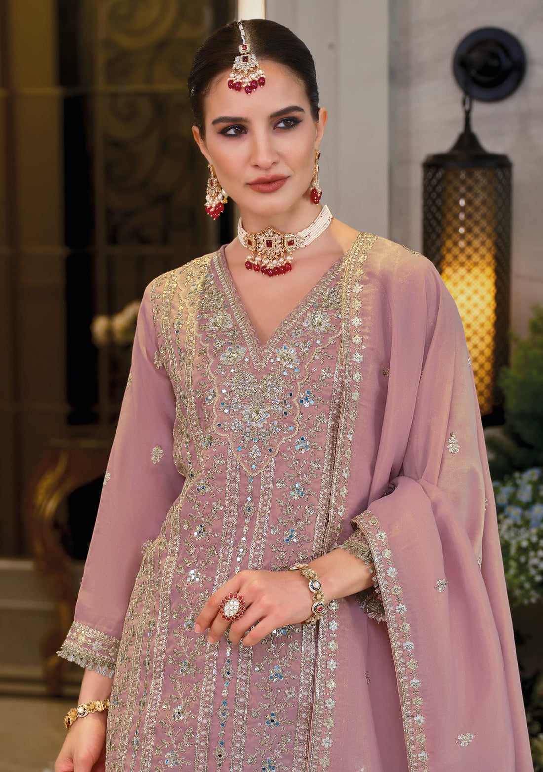 Front of a model standing wearing a pink sharara.