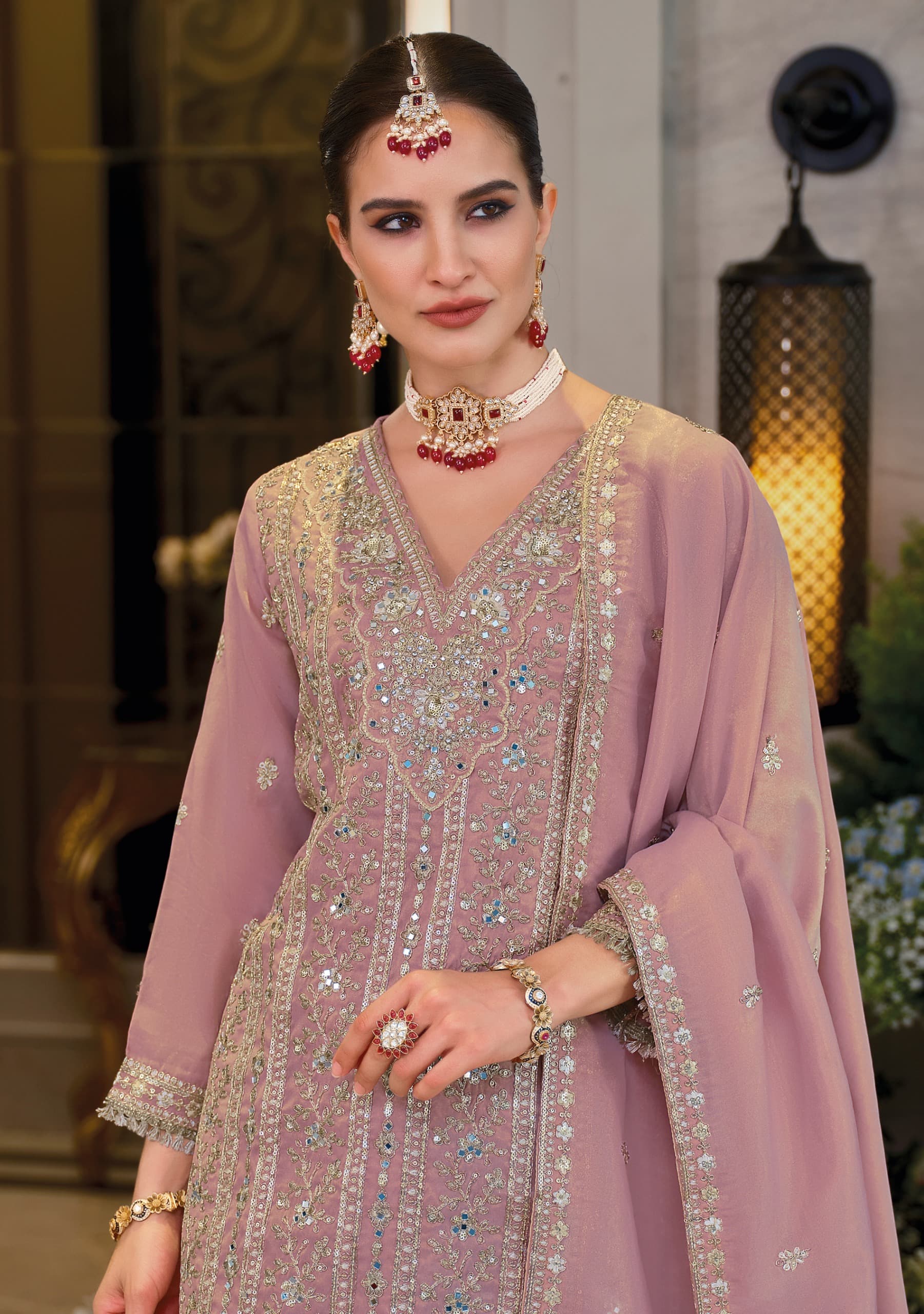 Front of a model standing wearing a pink sharara.