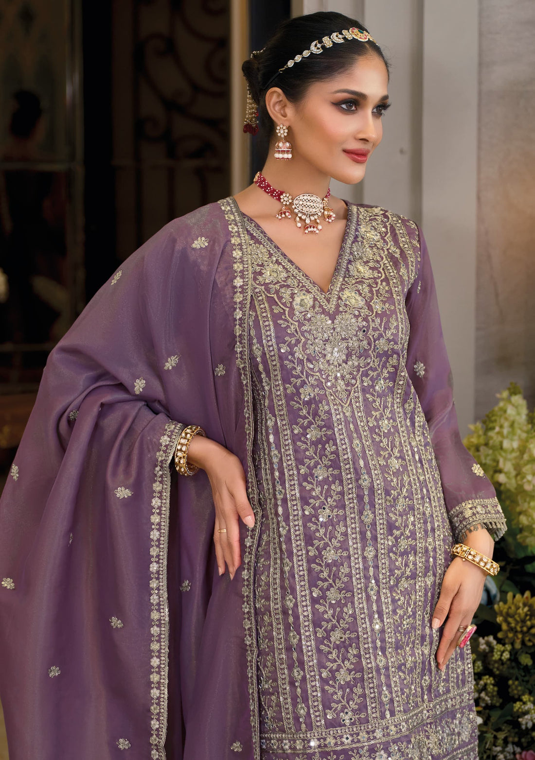 Front of a model wearing a purple sharara standing.