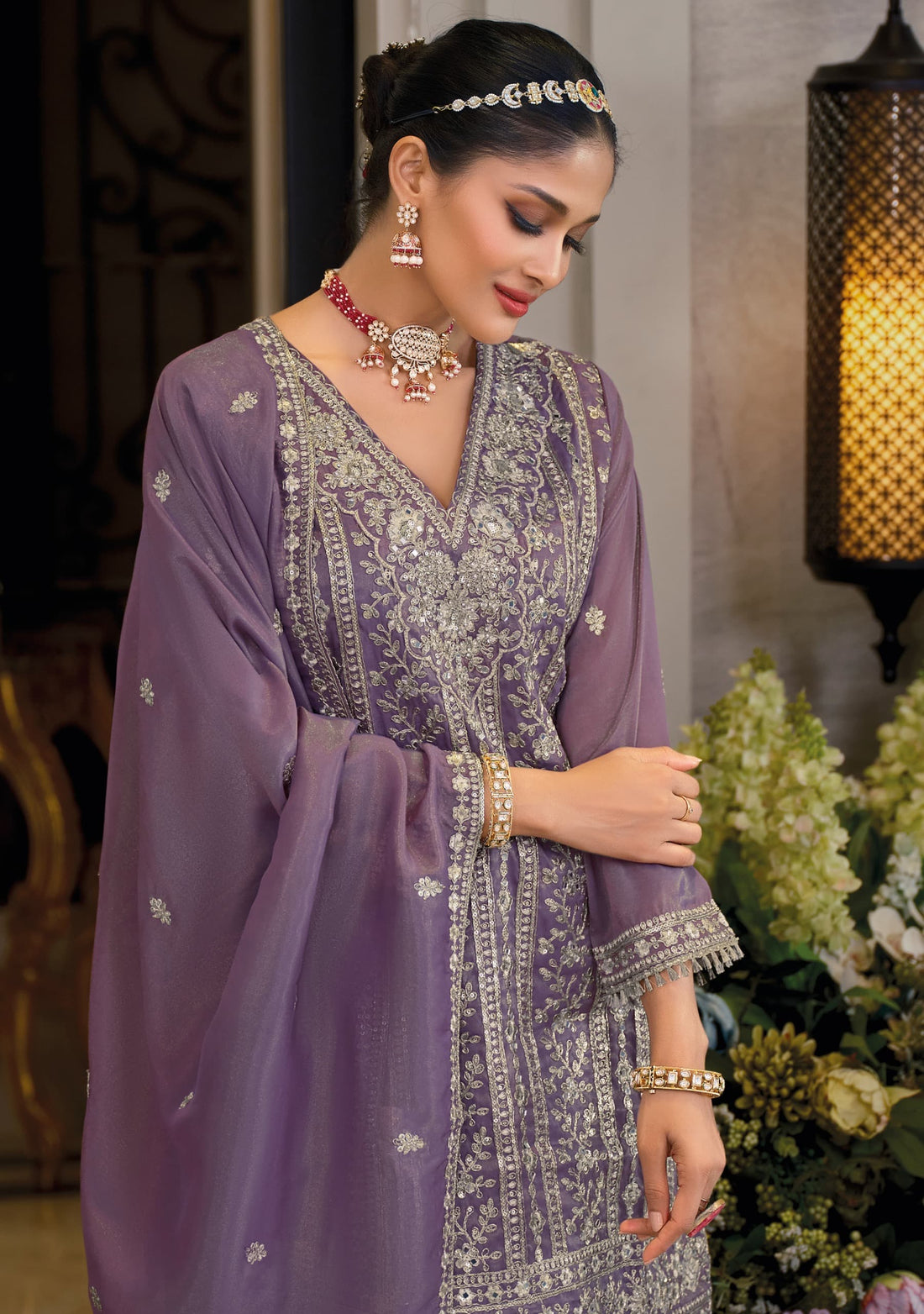 Front of a model standing wearing a purple sharara .