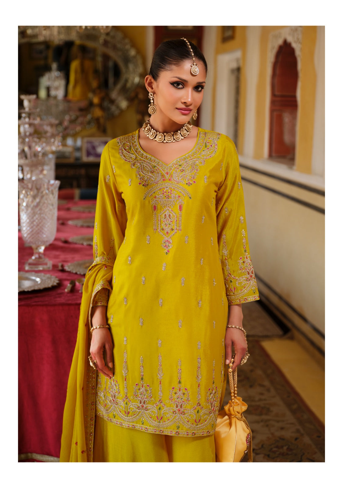 Front of a model standing wearing a yellow sharara.