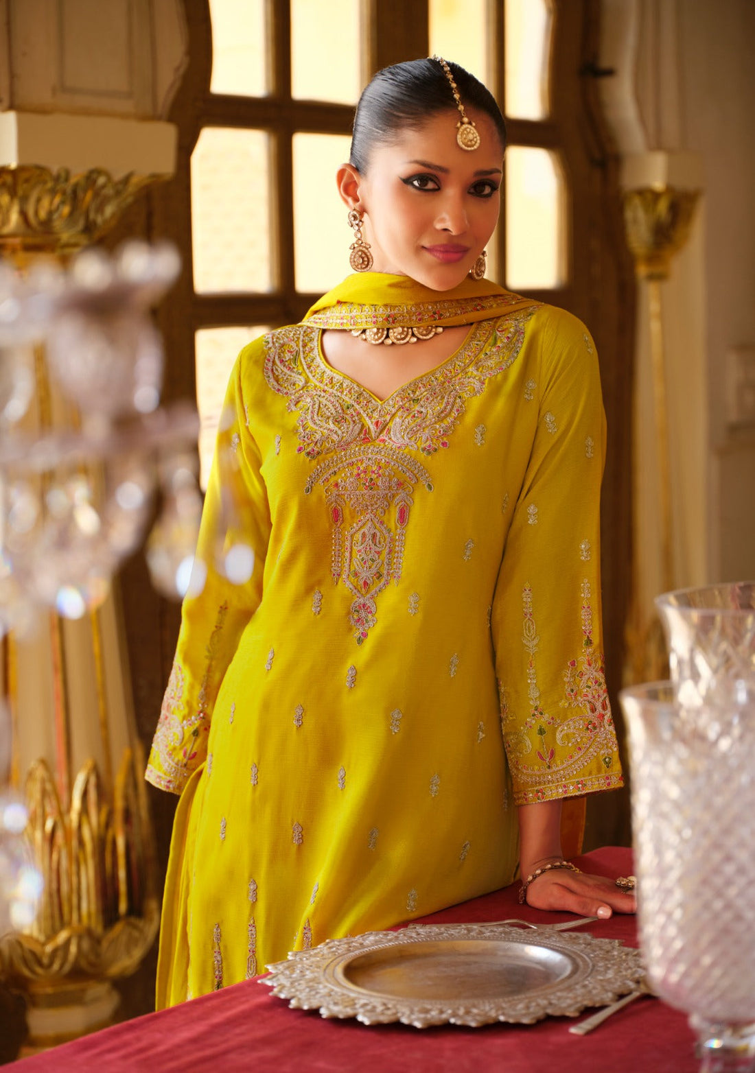 Front of a model standing wearing a yellow sharara.