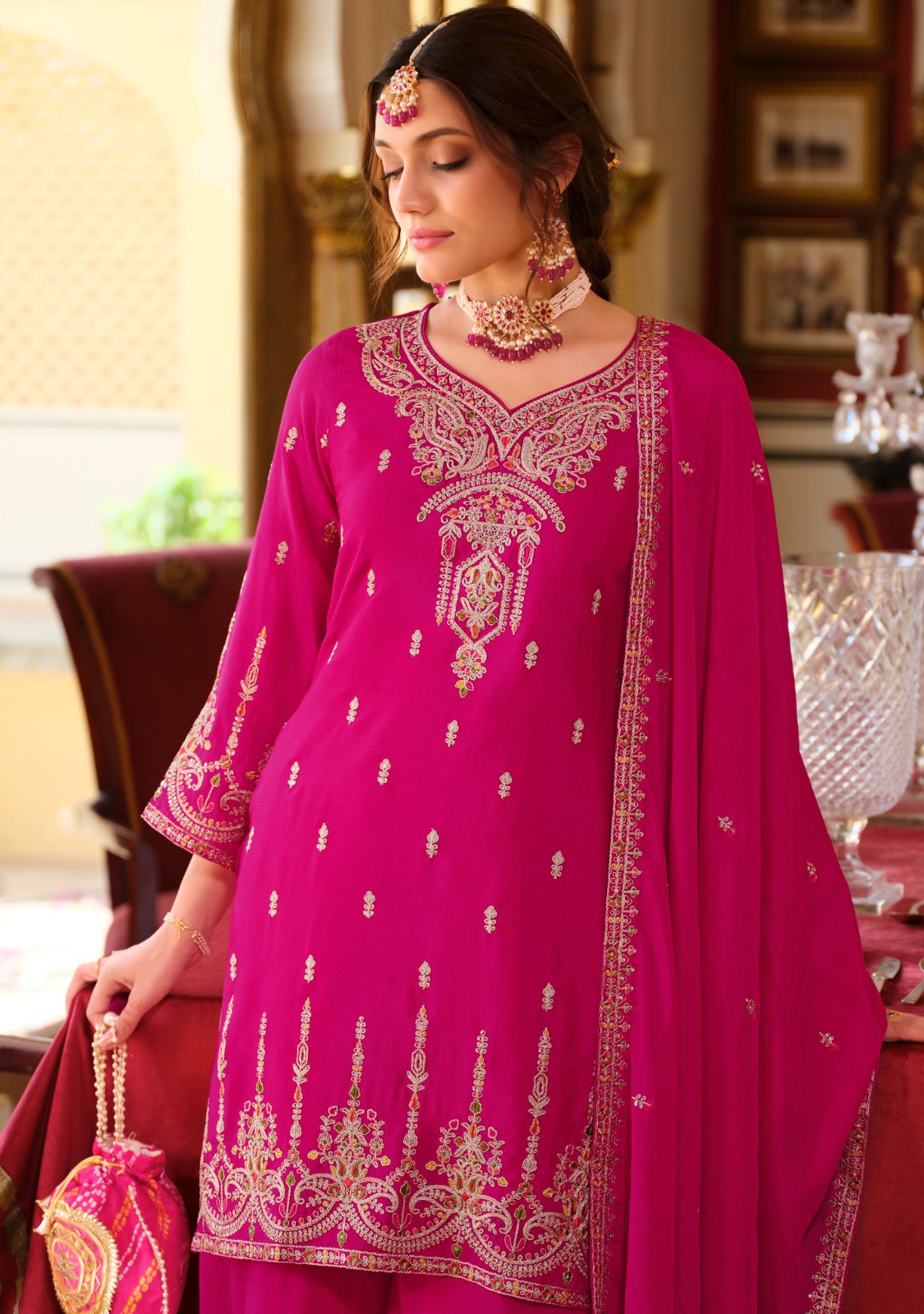 Front of a Model standing wearing a pink sharara.
