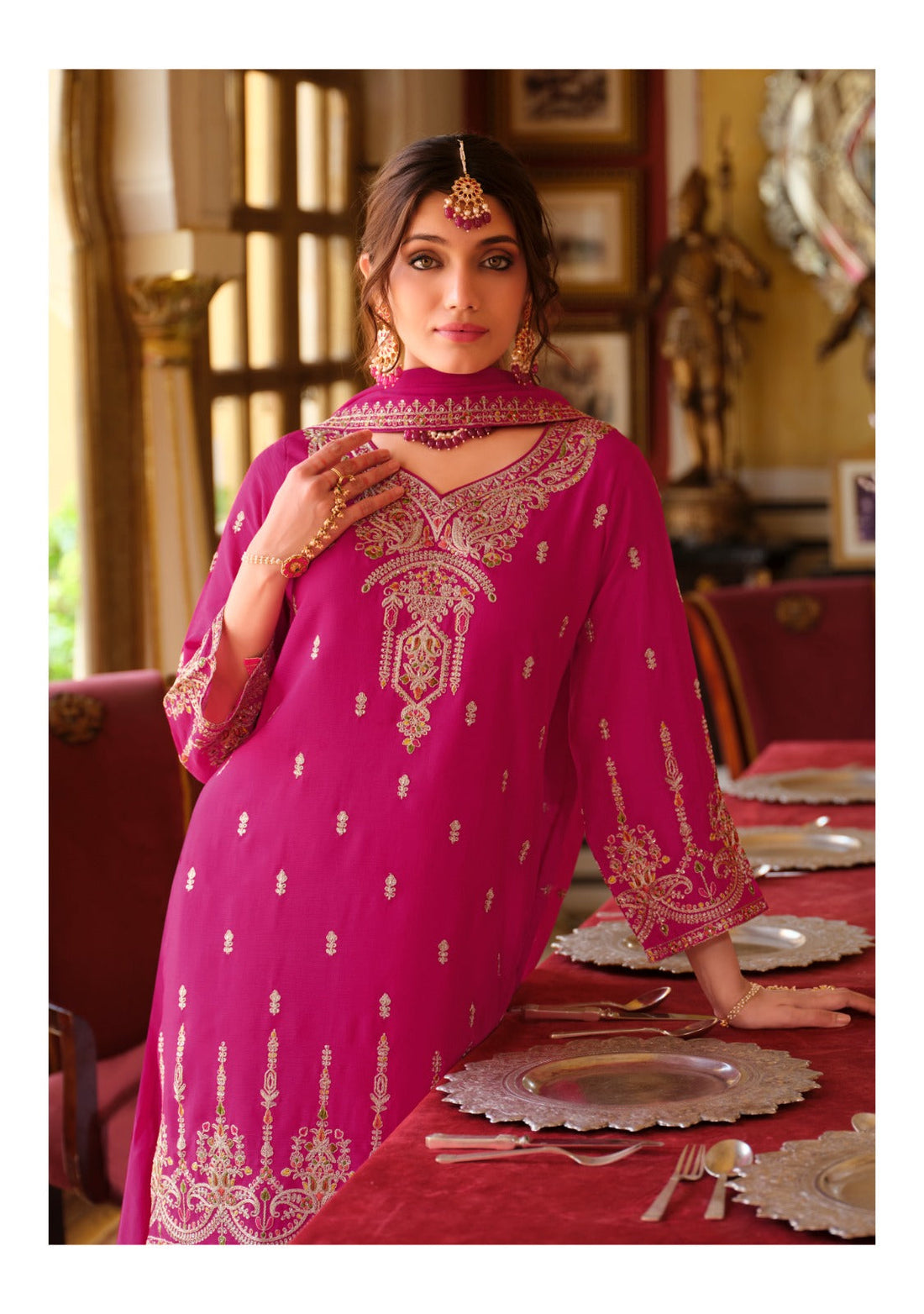 Model standing wearing a pink sharara.
