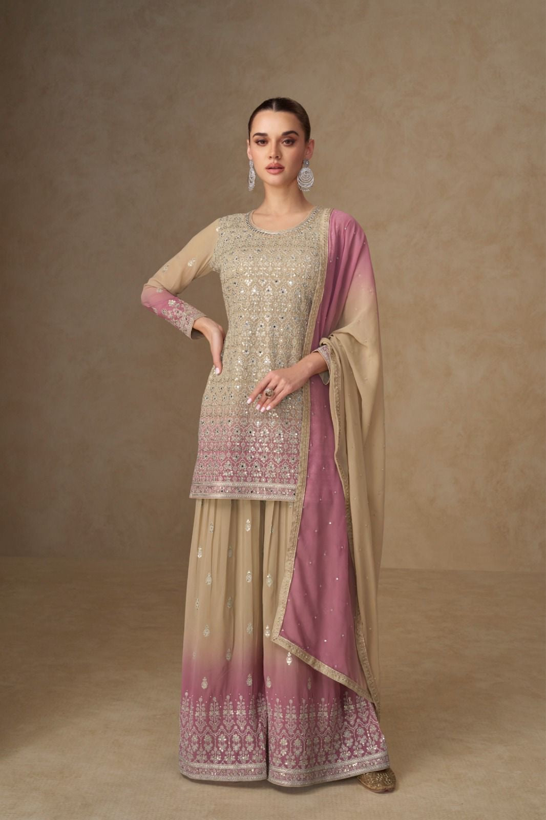 Woman wearing a traditional outfit with a beige and pink dupatta against a beige background