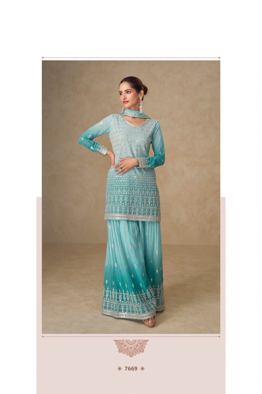 Woman wearing a turquoise traditional outfit with intricate patterns on a beige background