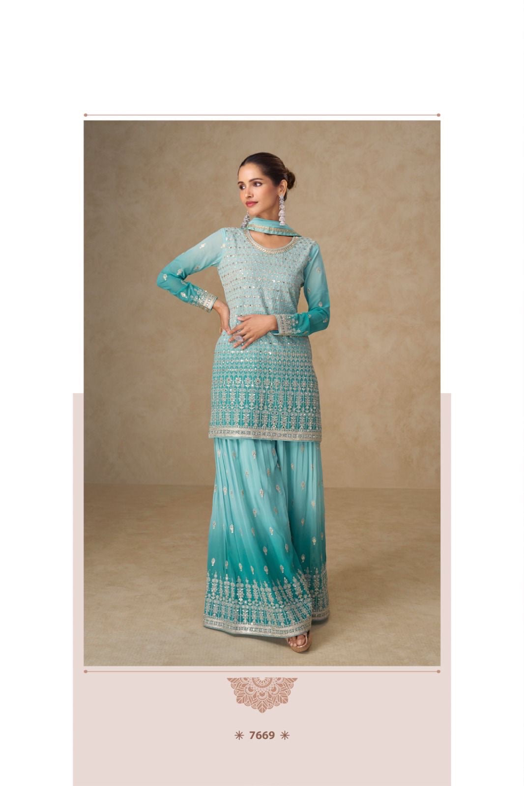 Woman wearing a turquoise traditional outfit with intricate patterns on a beige background