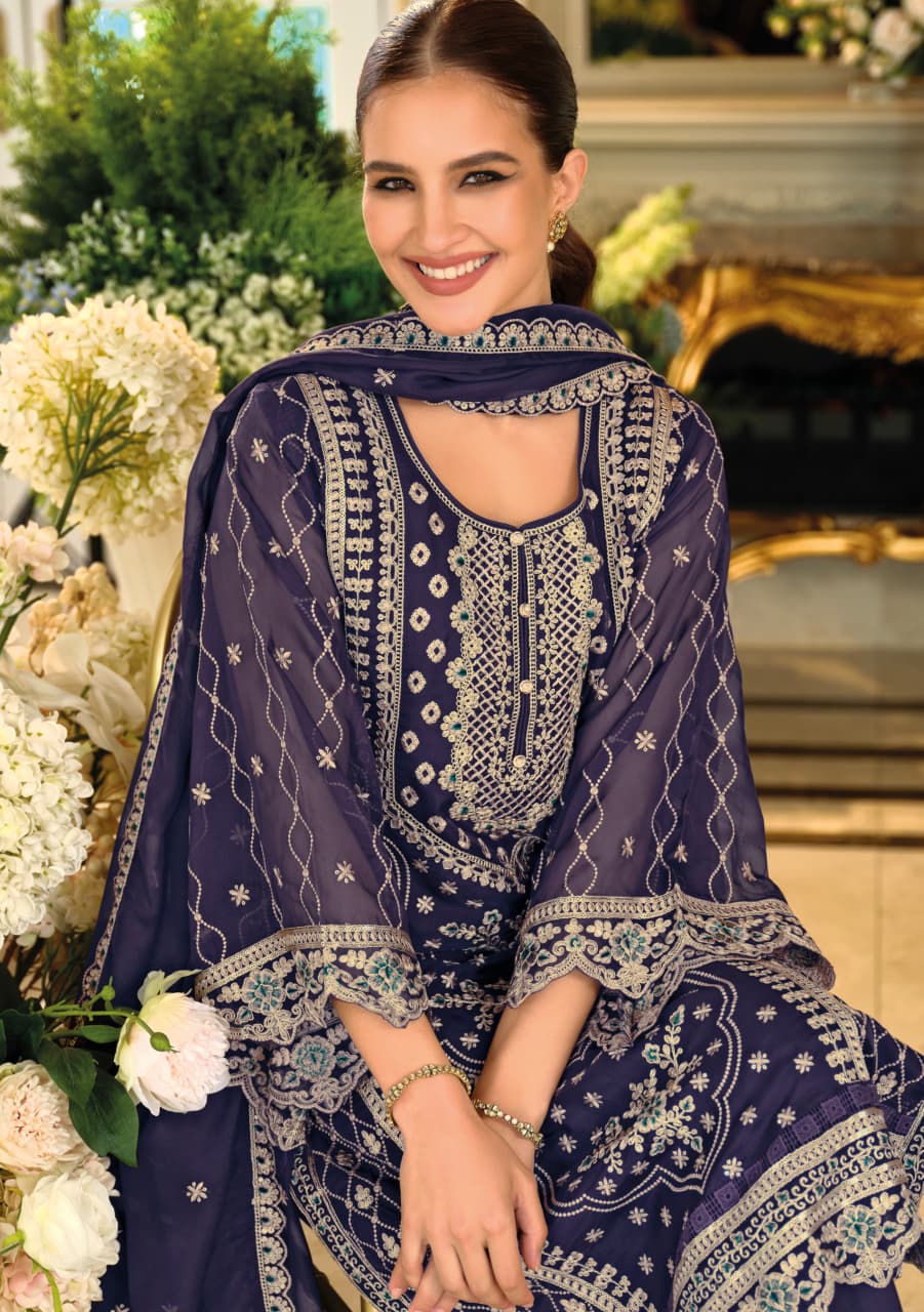 Woman wearing a dark blue embroidered traditional outfit with a floral background